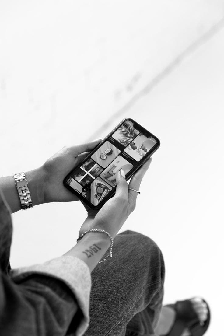 Hands holding a phone with a creator feed